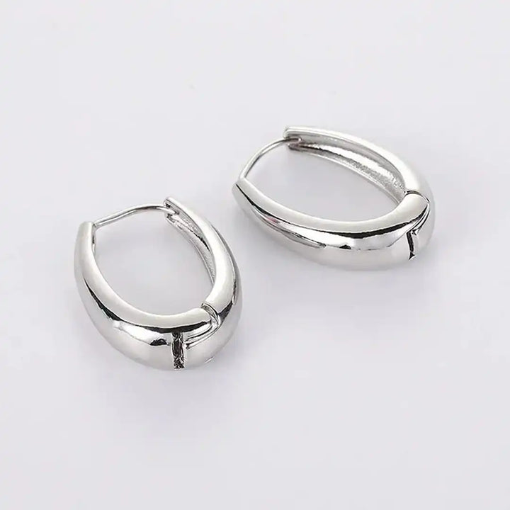 Earrings laid flat on a neutral background
