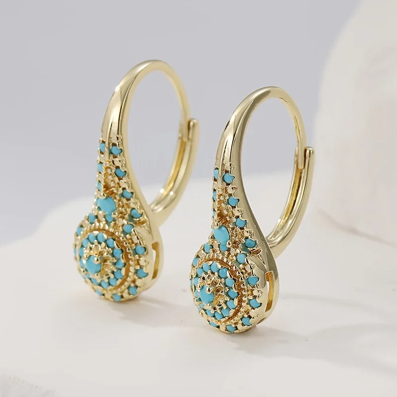 Pearl bloom earrings shown against a soft pink background