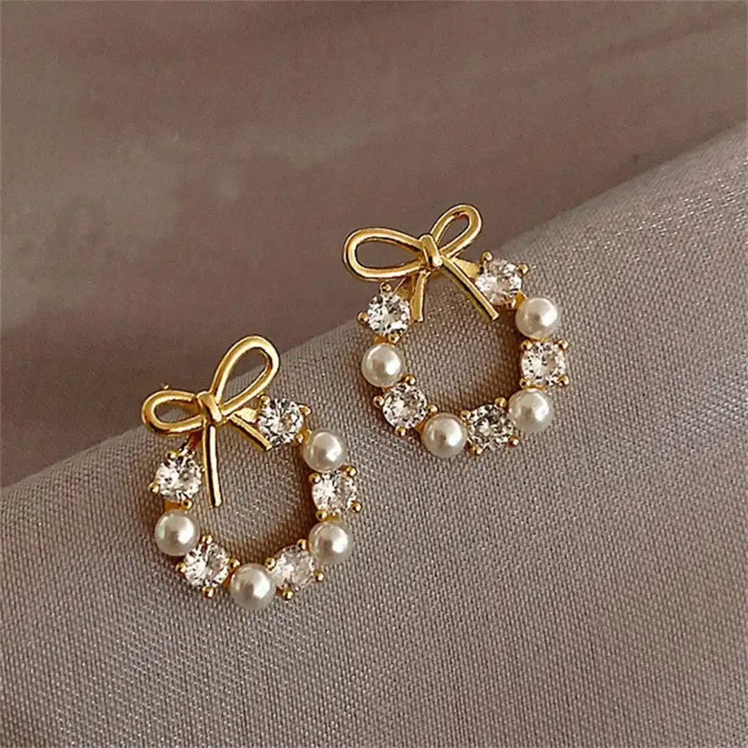 Main shot of the bow and pearl circle stud earrings