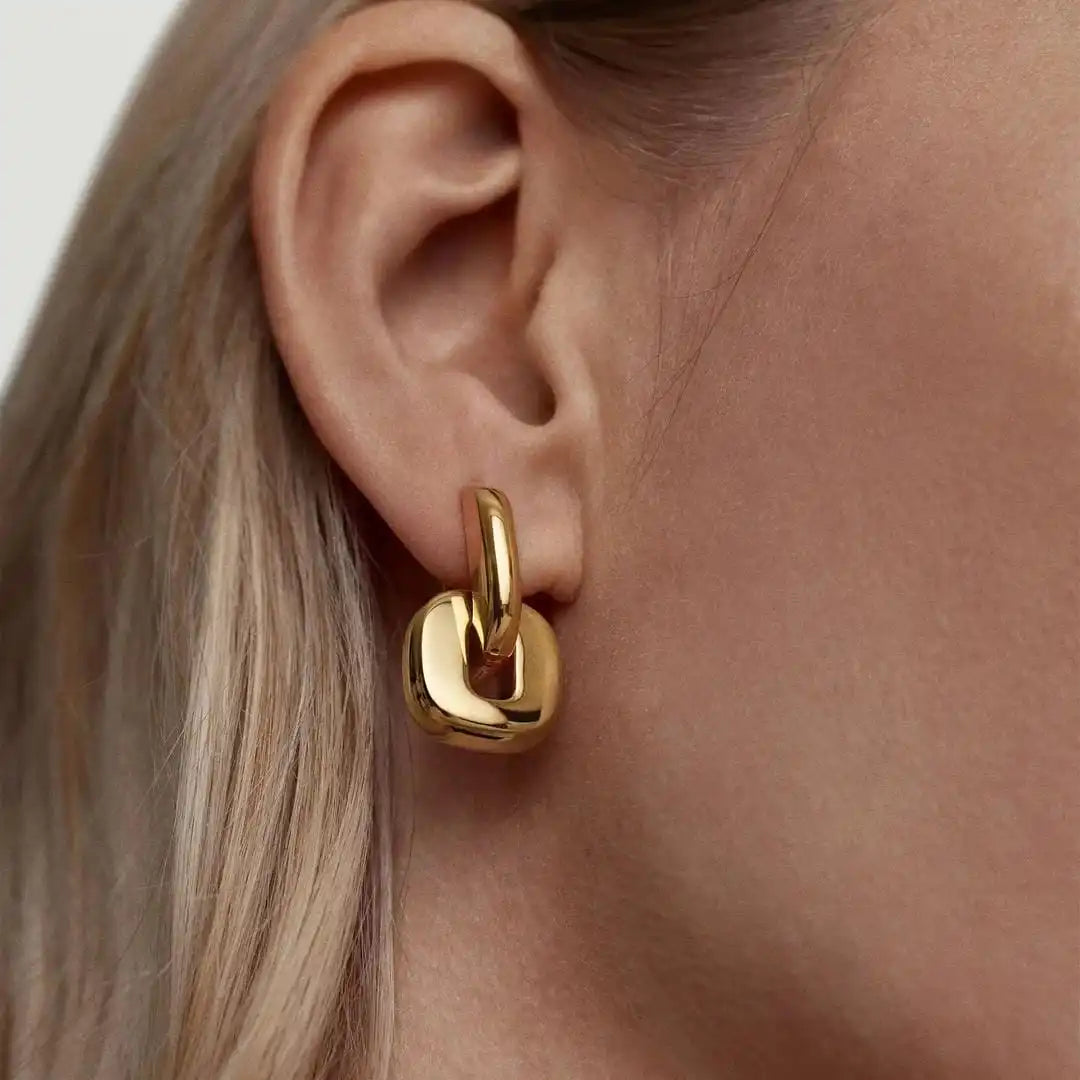 Main shot of the minimalist two tone gold oval earrings