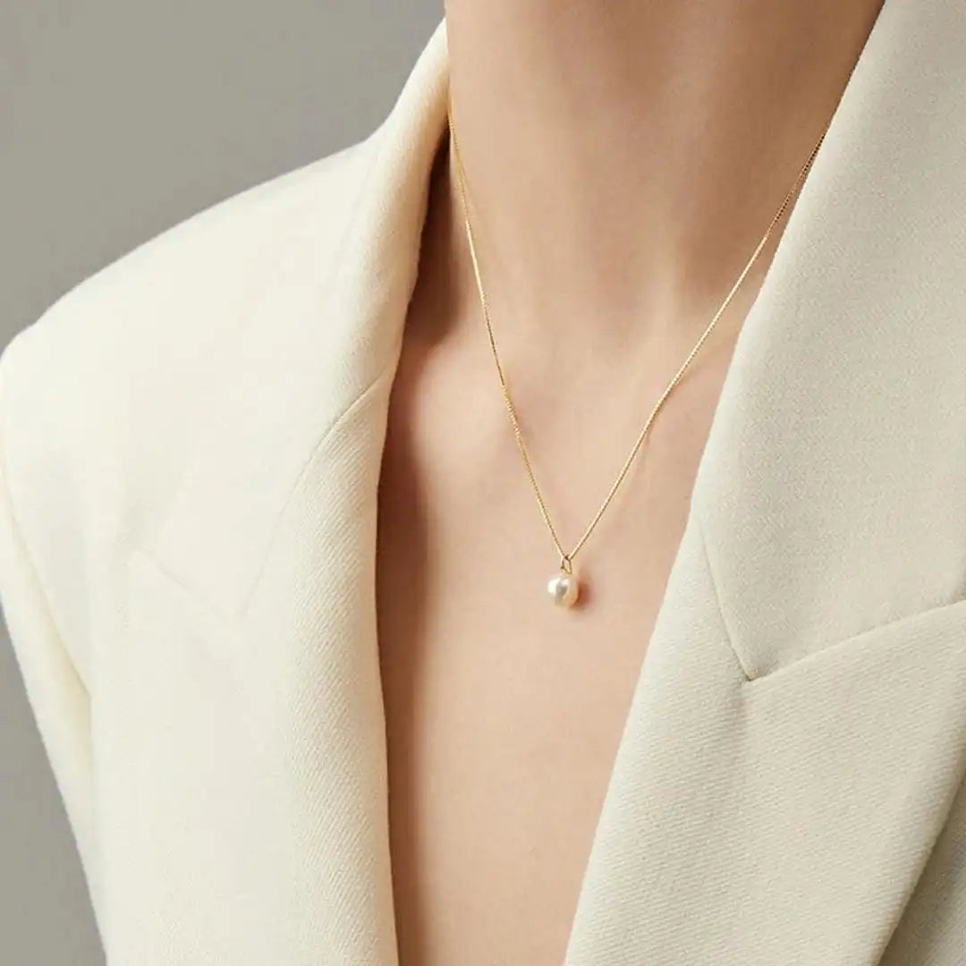Necklace worn on a model's neckline