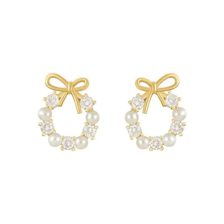 Earrings laid flat on a neutral background