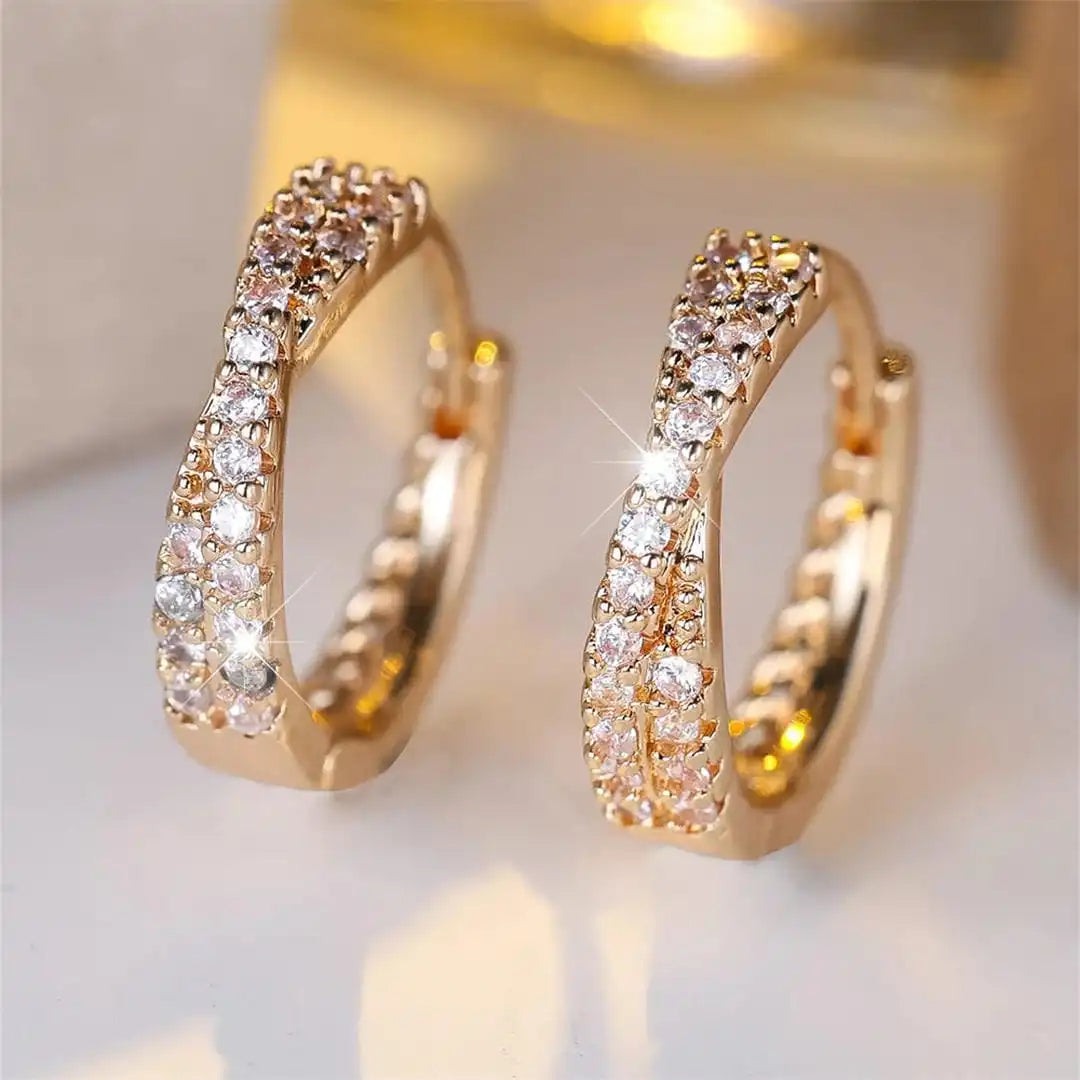 Main shot of the crossed zirconia hoop earrings