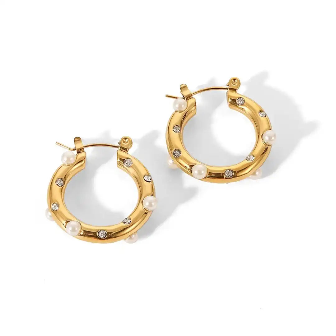 Earrings laid flat on a neutral background