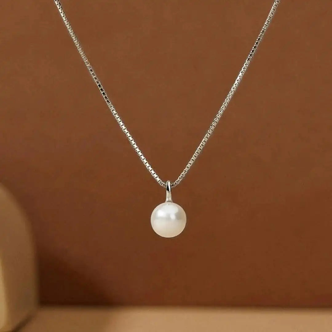 Close-up of the pearl pendant detail