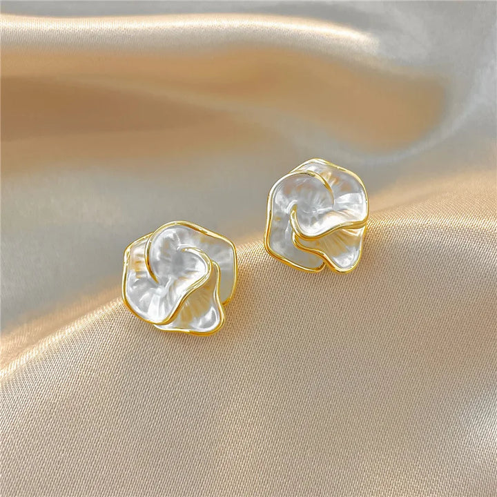 Pearl flower stud earrings shown on a white background