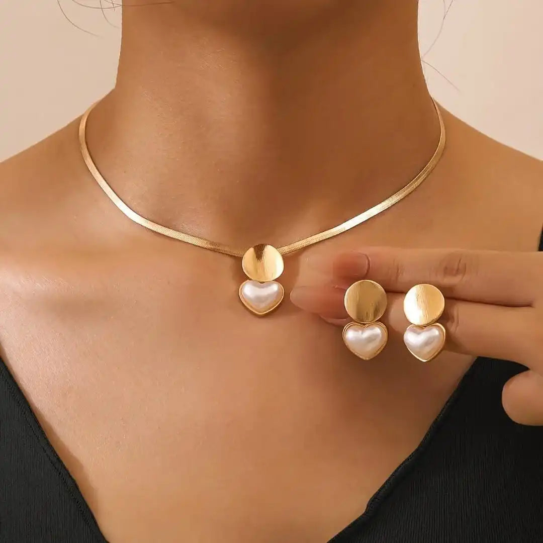 Main shot of the gold heart necklace and earrings set