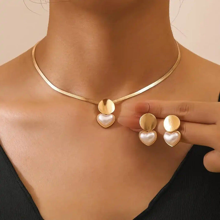 Main shot of the gold heart necklace and earrings set
