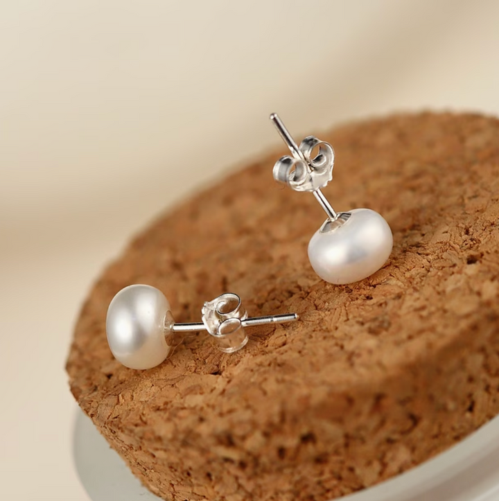 Classic ivory pearl stud earrings shown in close-up product view