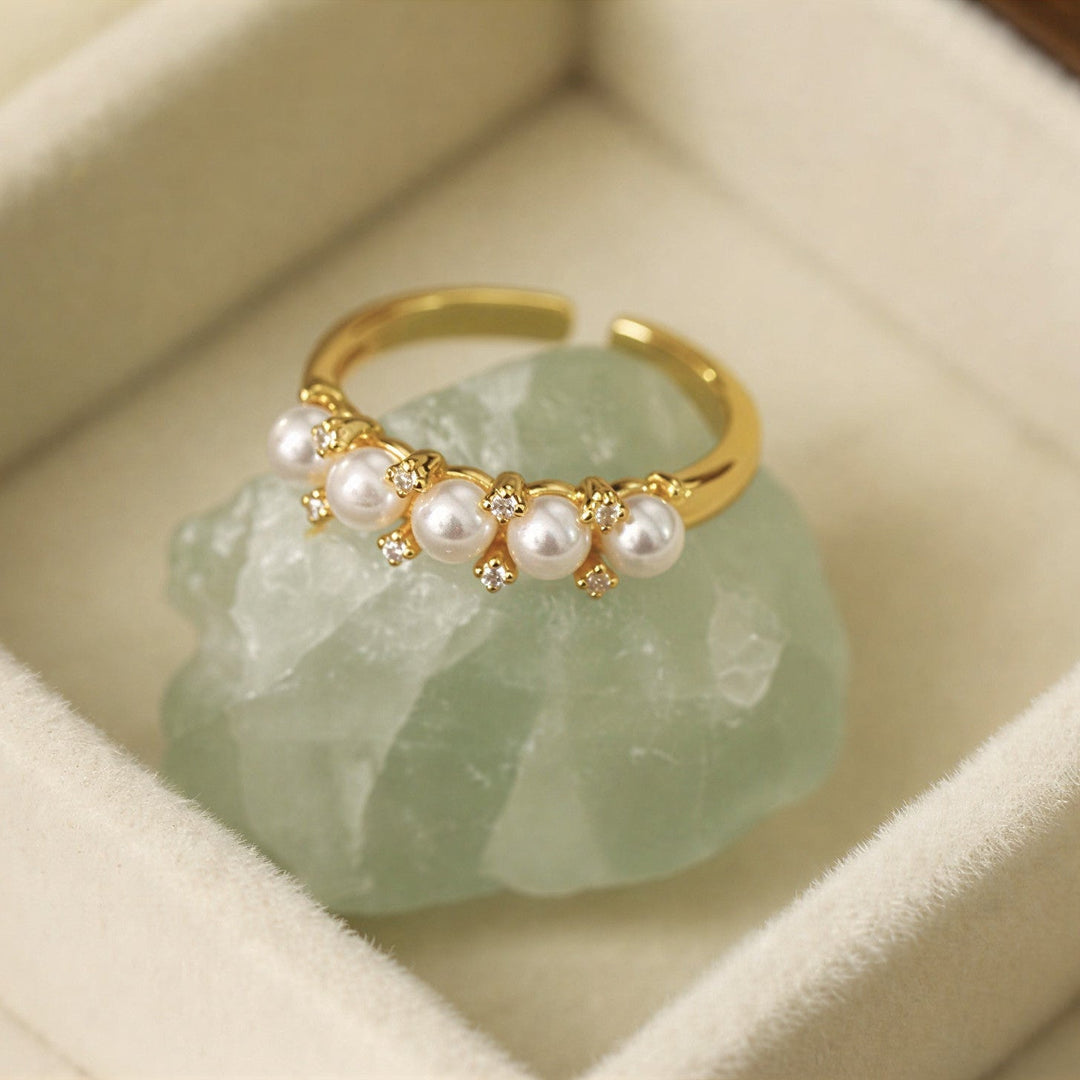 Five pearl row statement ring shown on a white background