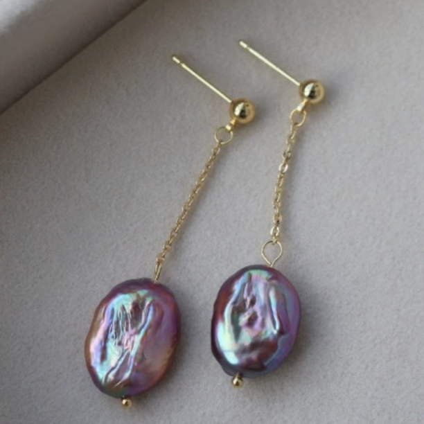 Peacock pearl long drop earrings shown in a styled product image