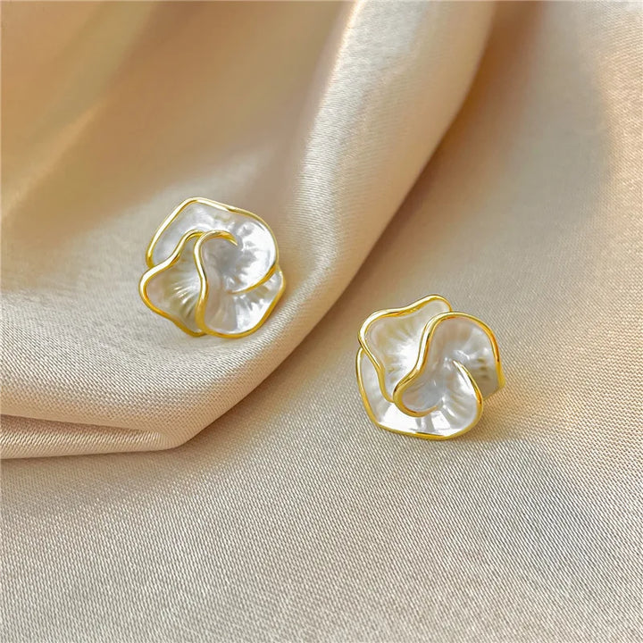 Pearl flower earrings photographed from a side angle