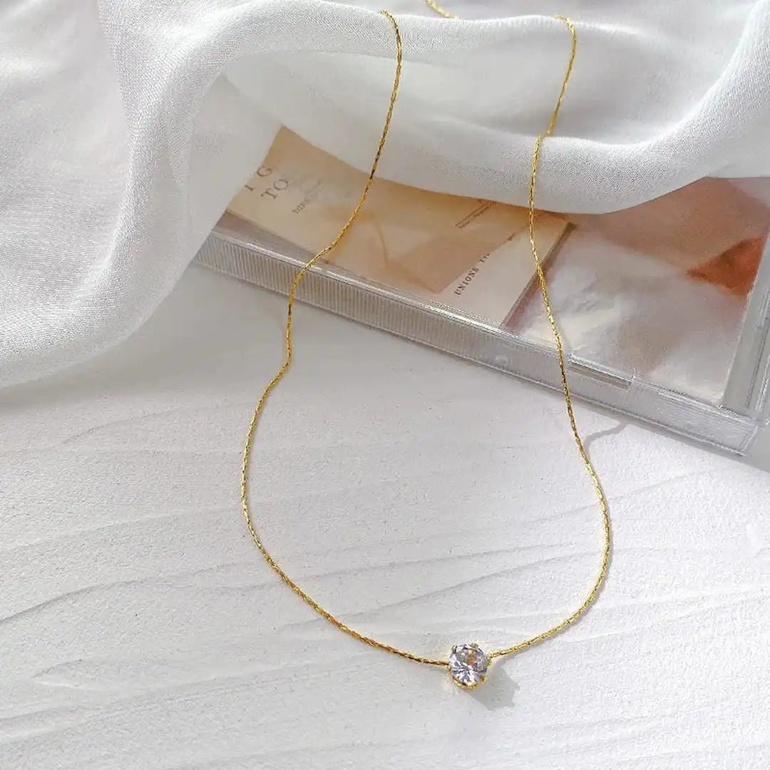 Necklace worn on a model's neckline