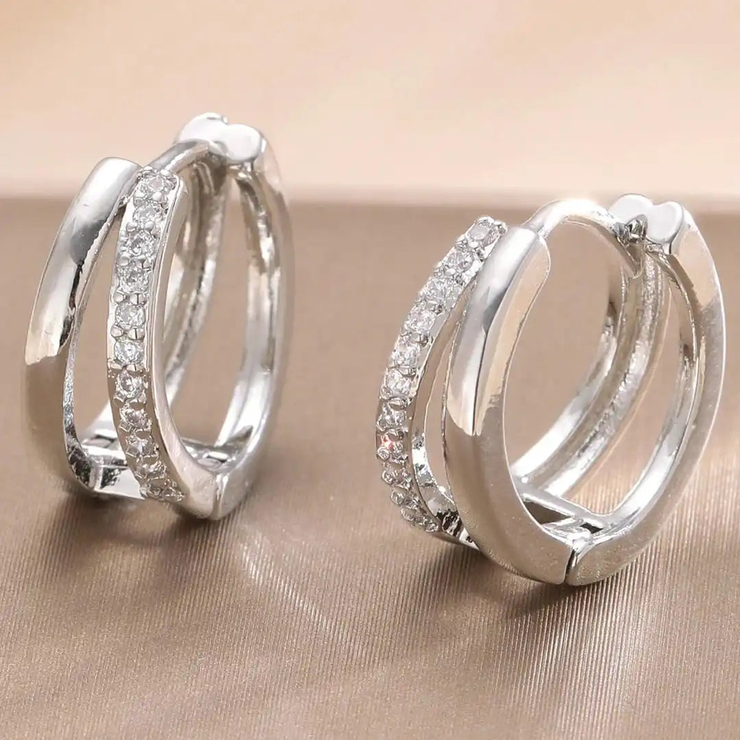 Earrings laid flat on a neutral background