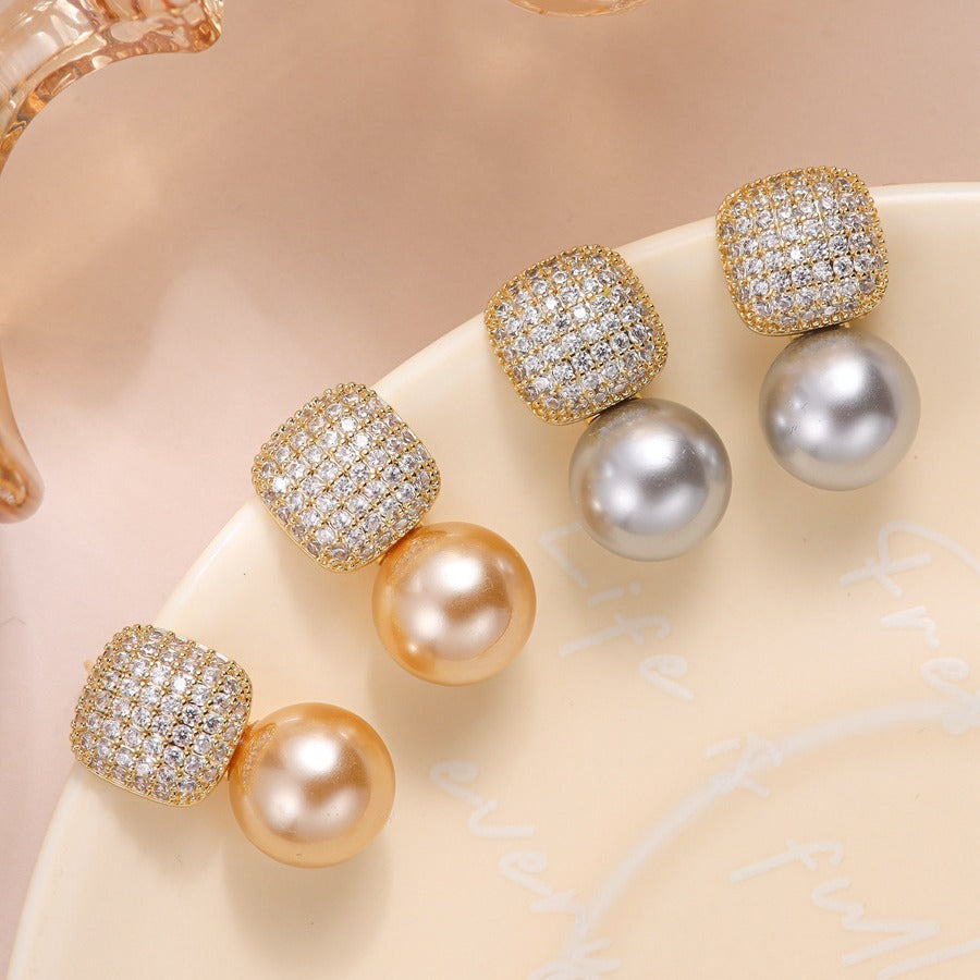 Model wearing the statement pearl earrings for scale