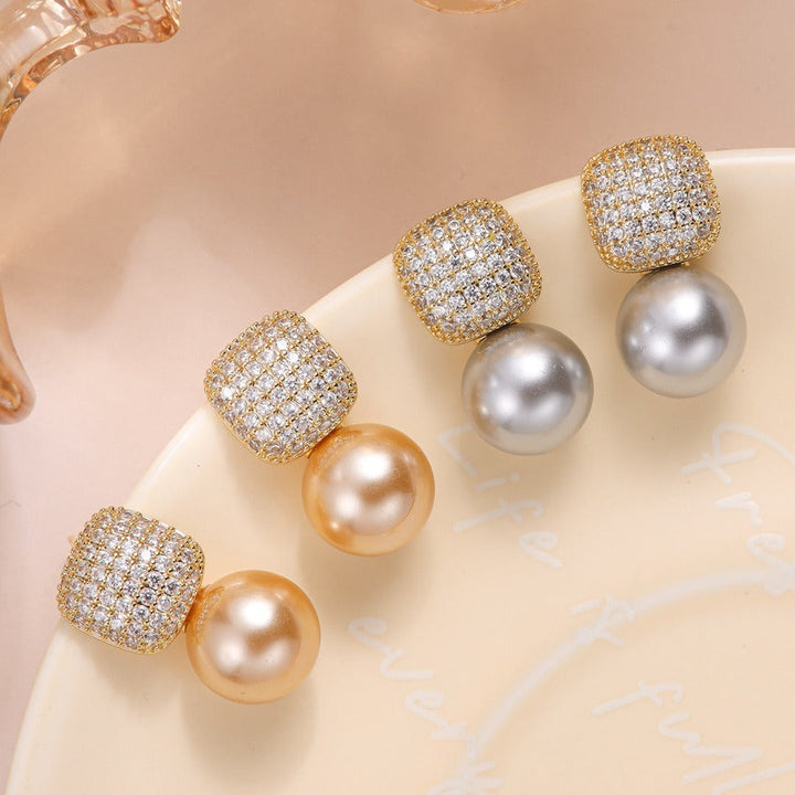 Model wearing the statement pearl earrings for scale