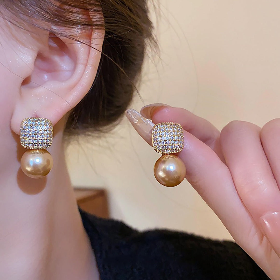 Side view highlighting the earring's drop length and shine