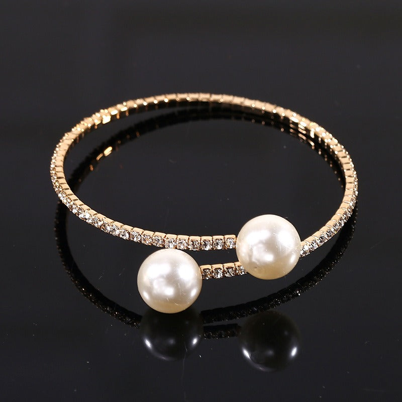Premium adjustable pearl bracelet laid flat on a plain backdrop