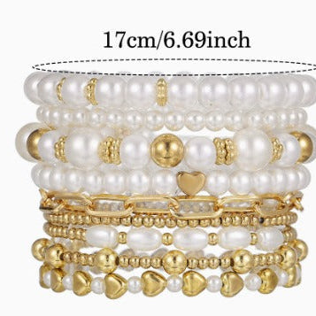Model wearing the full pearl stacking bracelet set on the wrist