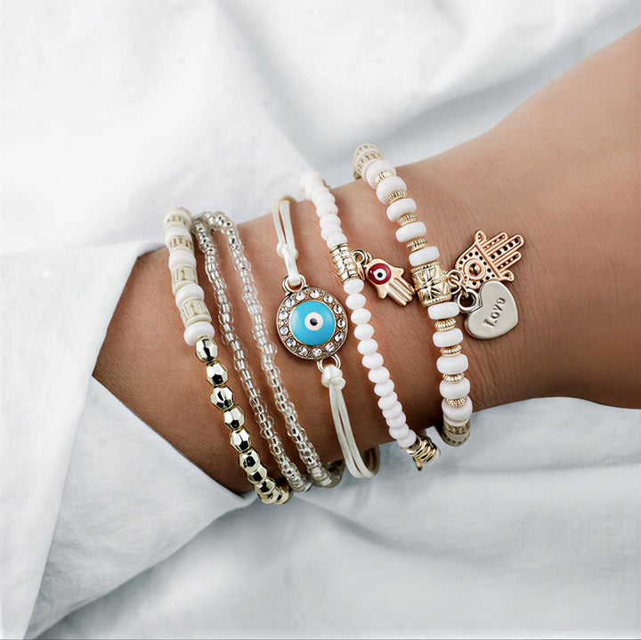 Elegant gold hamsa bracelet bundle laid out together