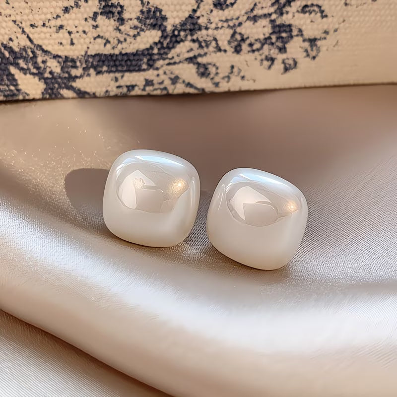 Pair of square pearl earrings displayed together