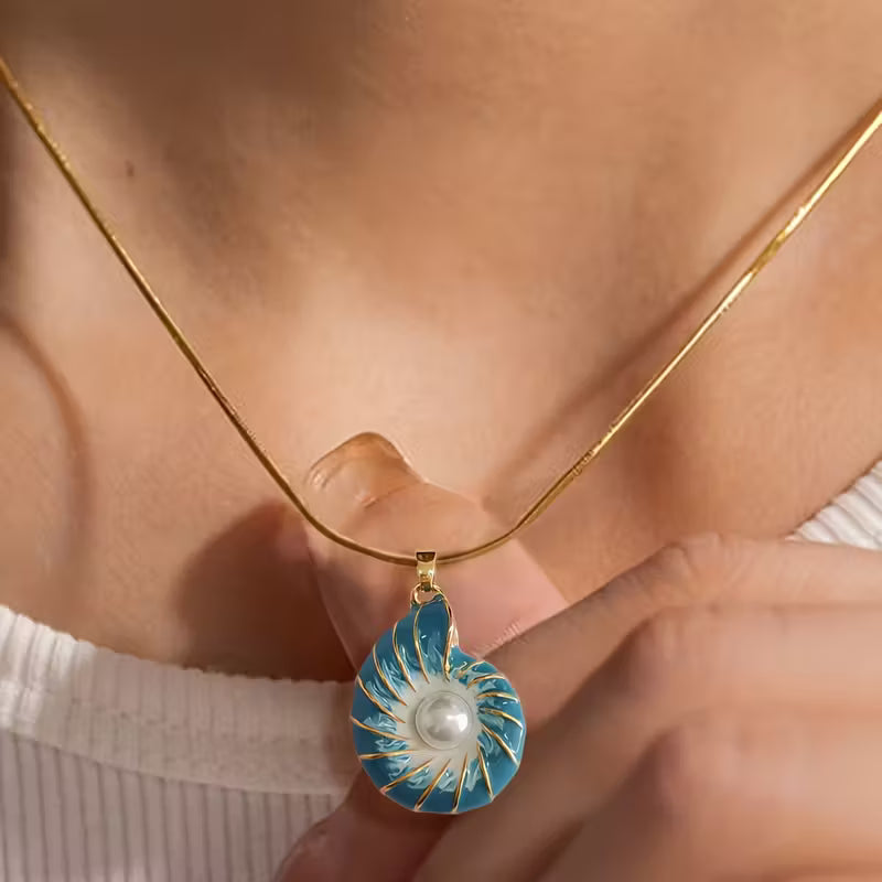 Close-up of the pearl nestled inside the seashell pendant