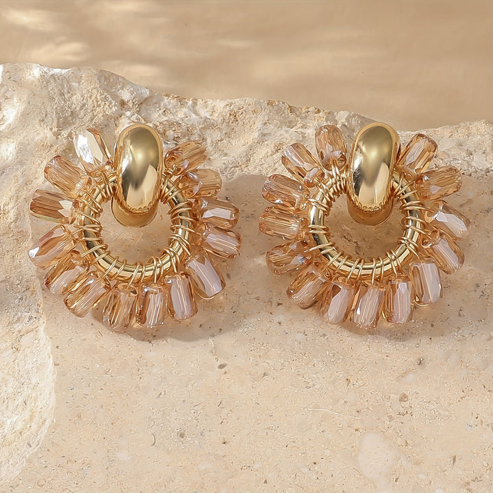 Pair of fan earrings displayed on a jewellery pad