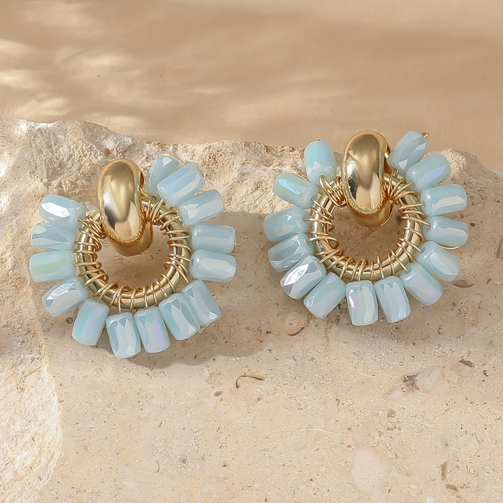 Earrings styled together with a matching necklace nearby