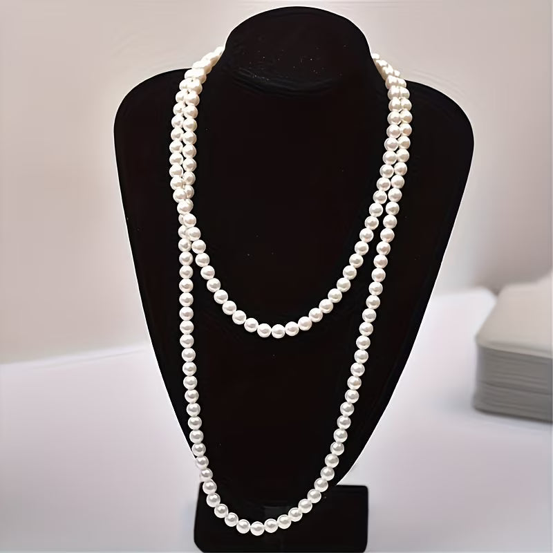 Double pearl necklace laid flat on a white background