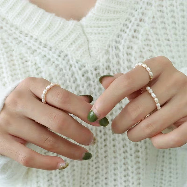 Close-up of the domed pearl set into the gold-tone band