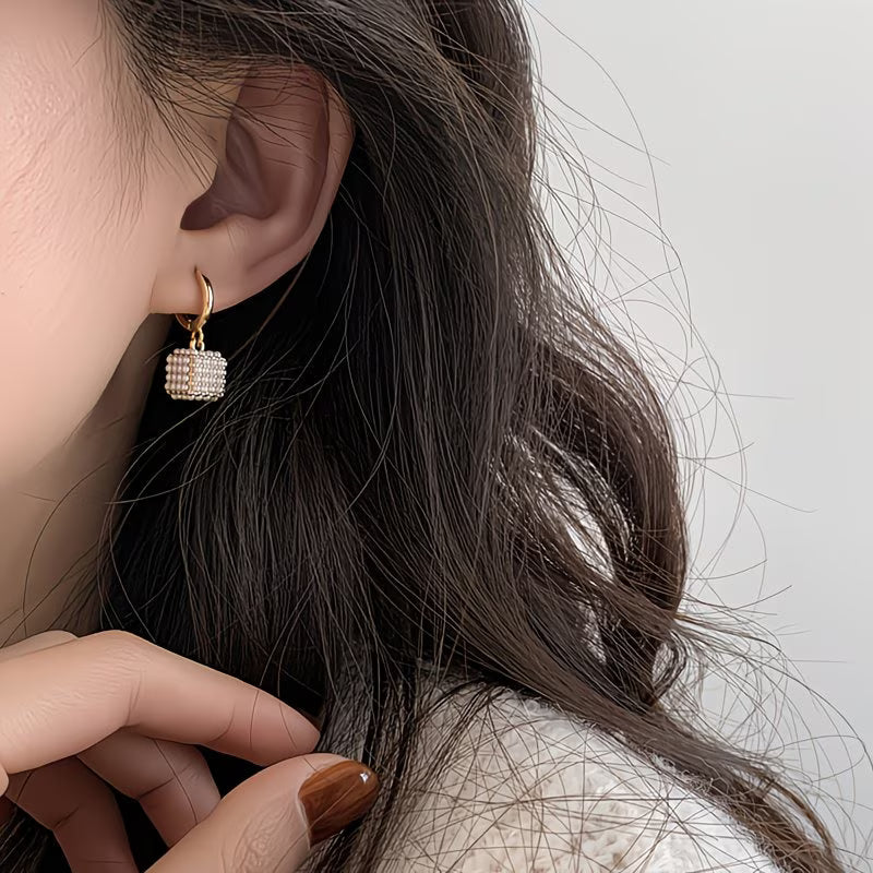 Model wearing the pearl cube stud earrings