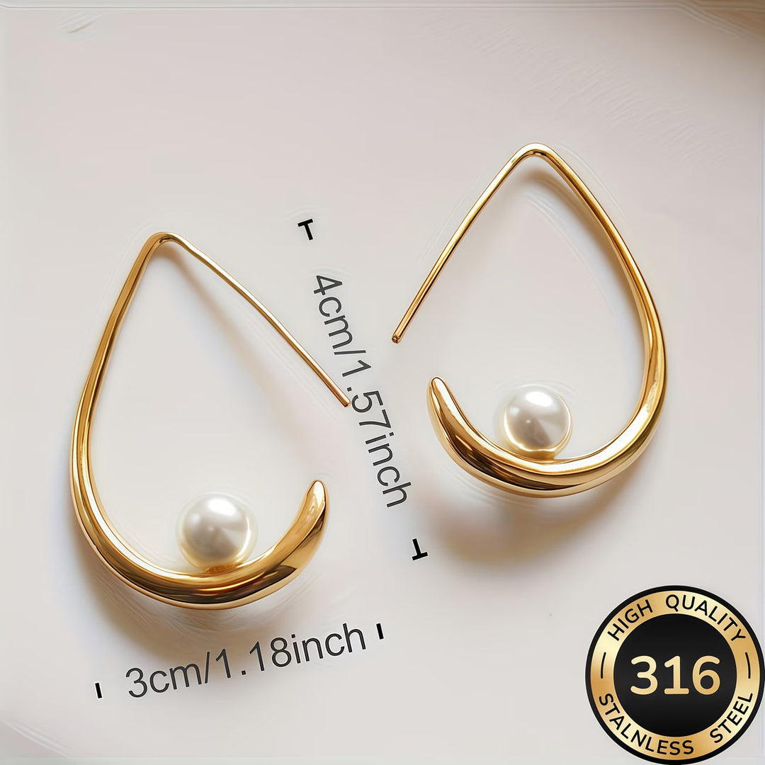 Crescent pearl hoop earrings worn on a model's ear