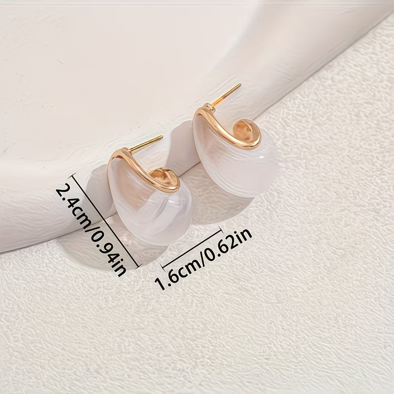 Close-up of the smooth teardrop pearl and gold-tone hook
