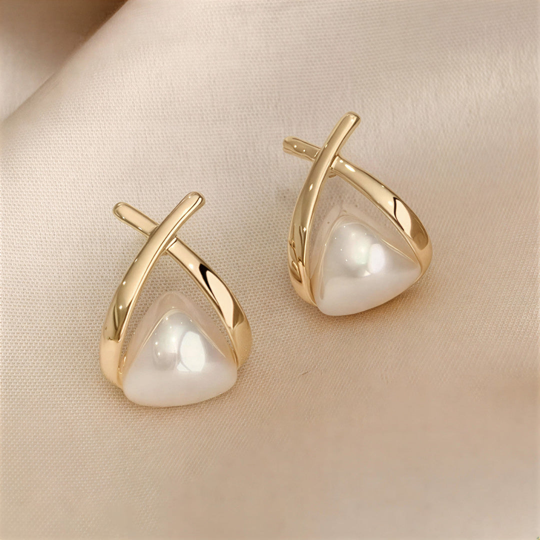 Pearl drop earrings shown on a plain white background