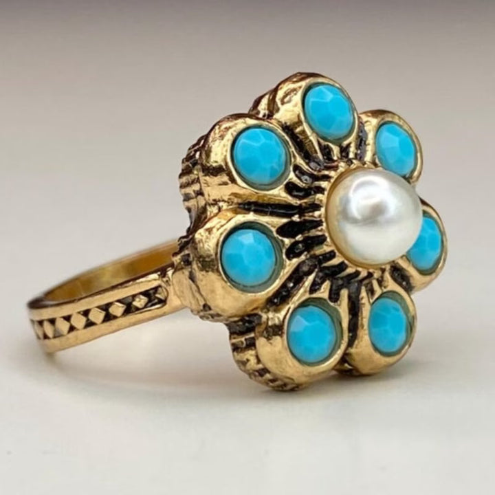 Top-down view of the pearl and turquoise setting