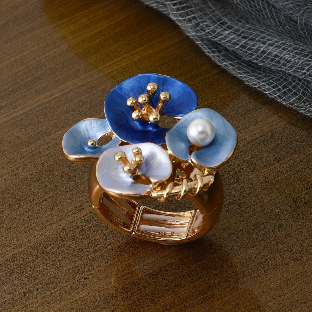 Blue floral pearl statement ring shown on a plain background