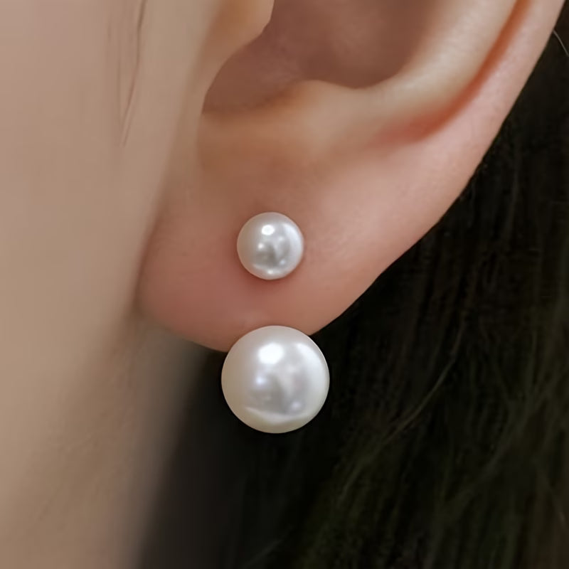 Double pearl statement earrings on a plain white background