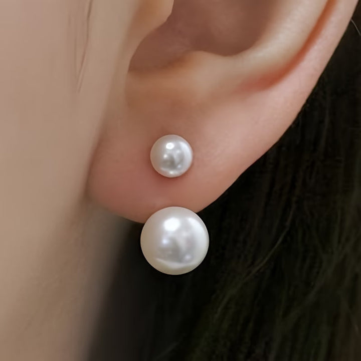 Double pearl statement earrings on a plain white background