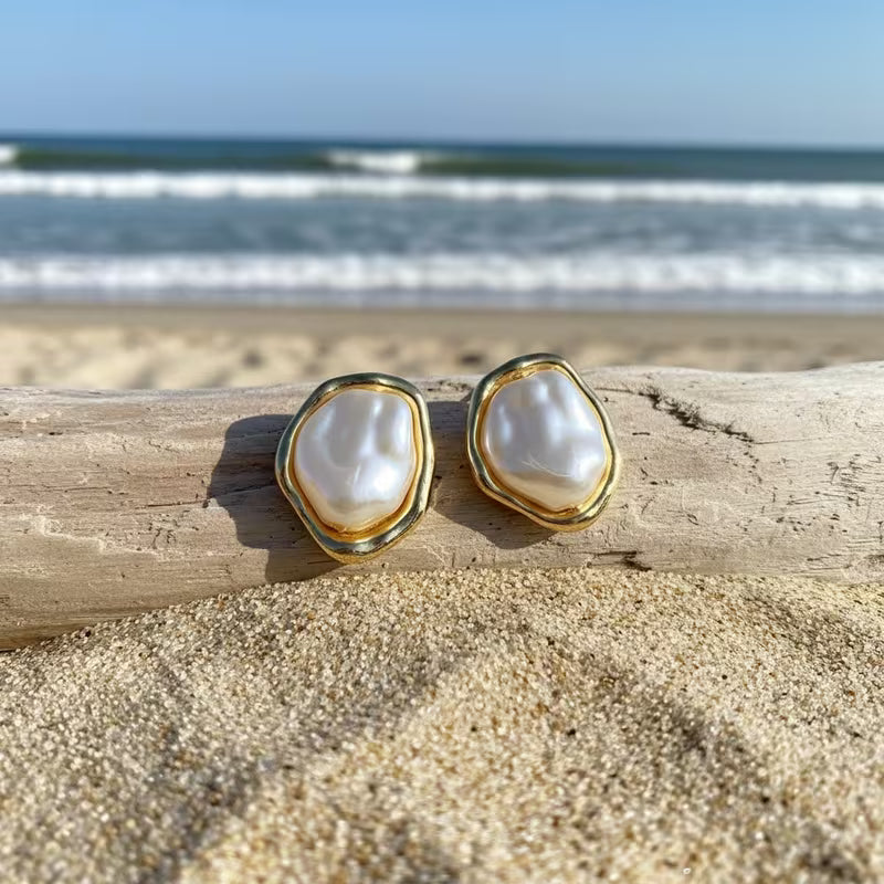 Close-up of a single lustrous pearl on the gold-tone hook