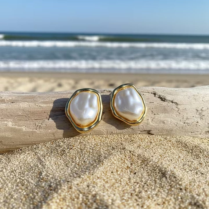 Close-up of a single lustrous pearl on the gold-tone hook