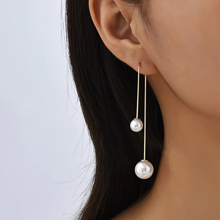 Radiant pearl statement earrings on a white background