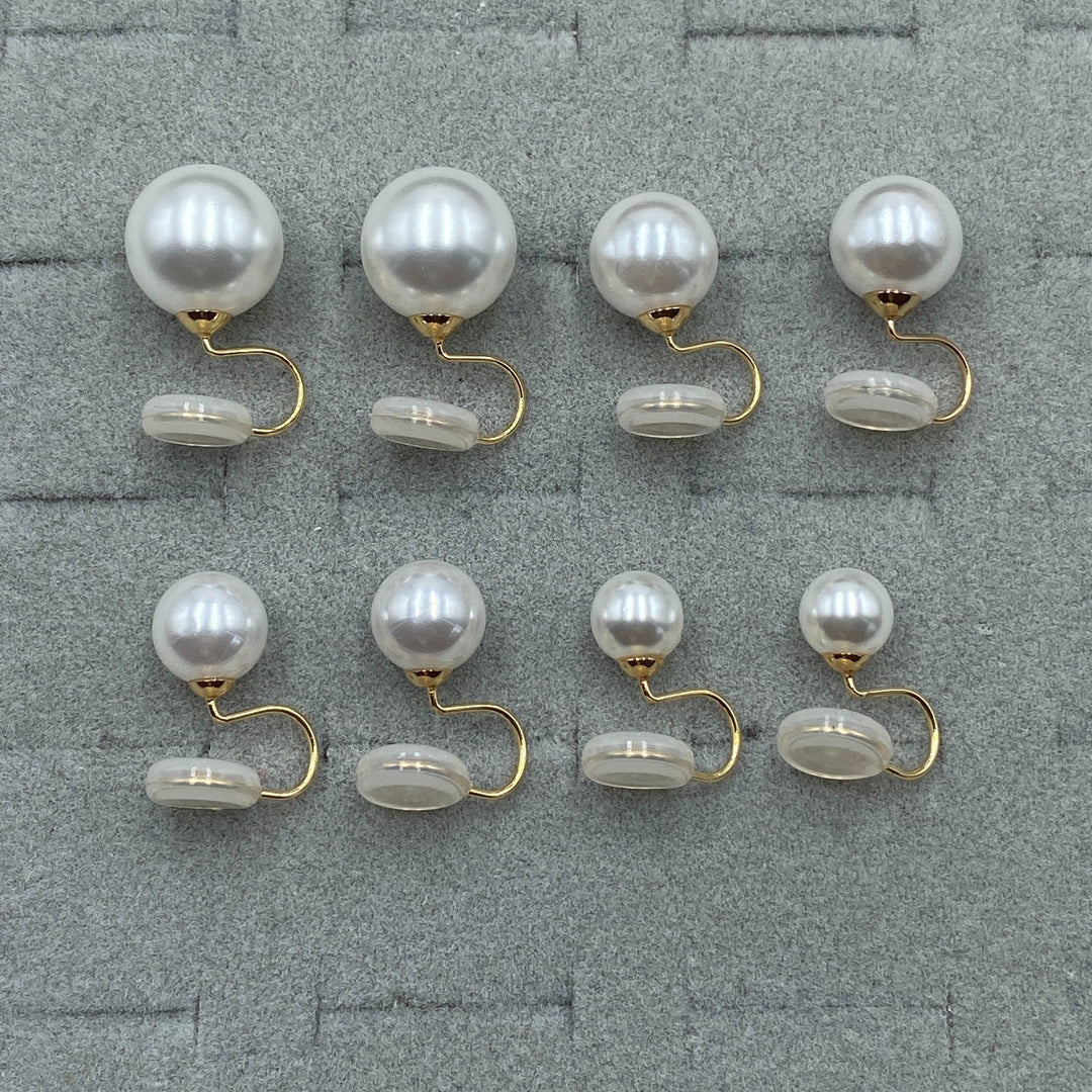 Clip-on pearl earrings worn in the ear to show the fit