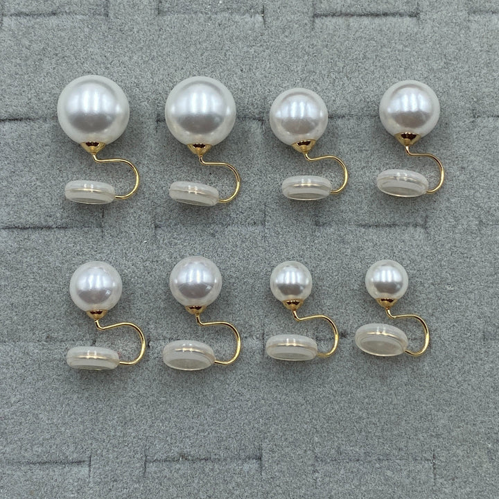 Clip-on pearl earrings worn in the ear to show the fit