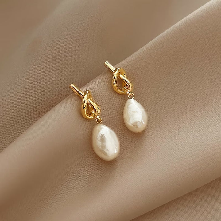 Model wearing the knotted pearl drop earrings