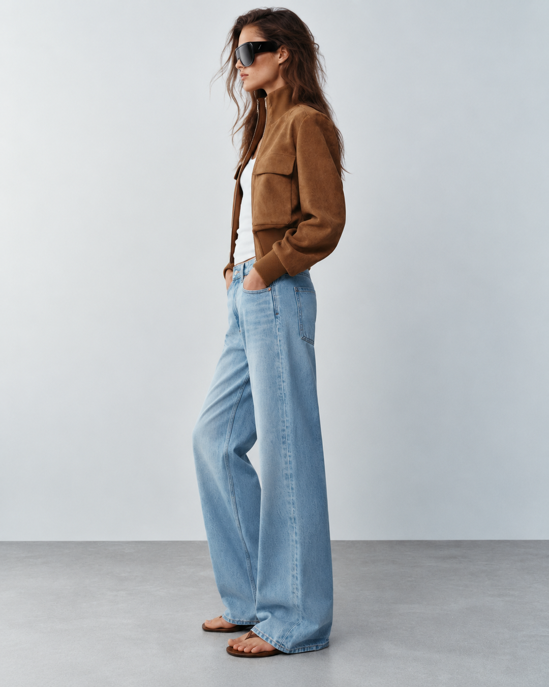 Side profile of light brown women's suede bomber jacket with blouson sleeves