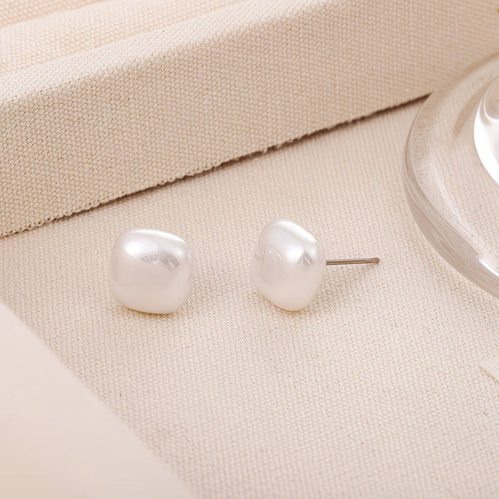 Model wearing the square pearl stud earrings