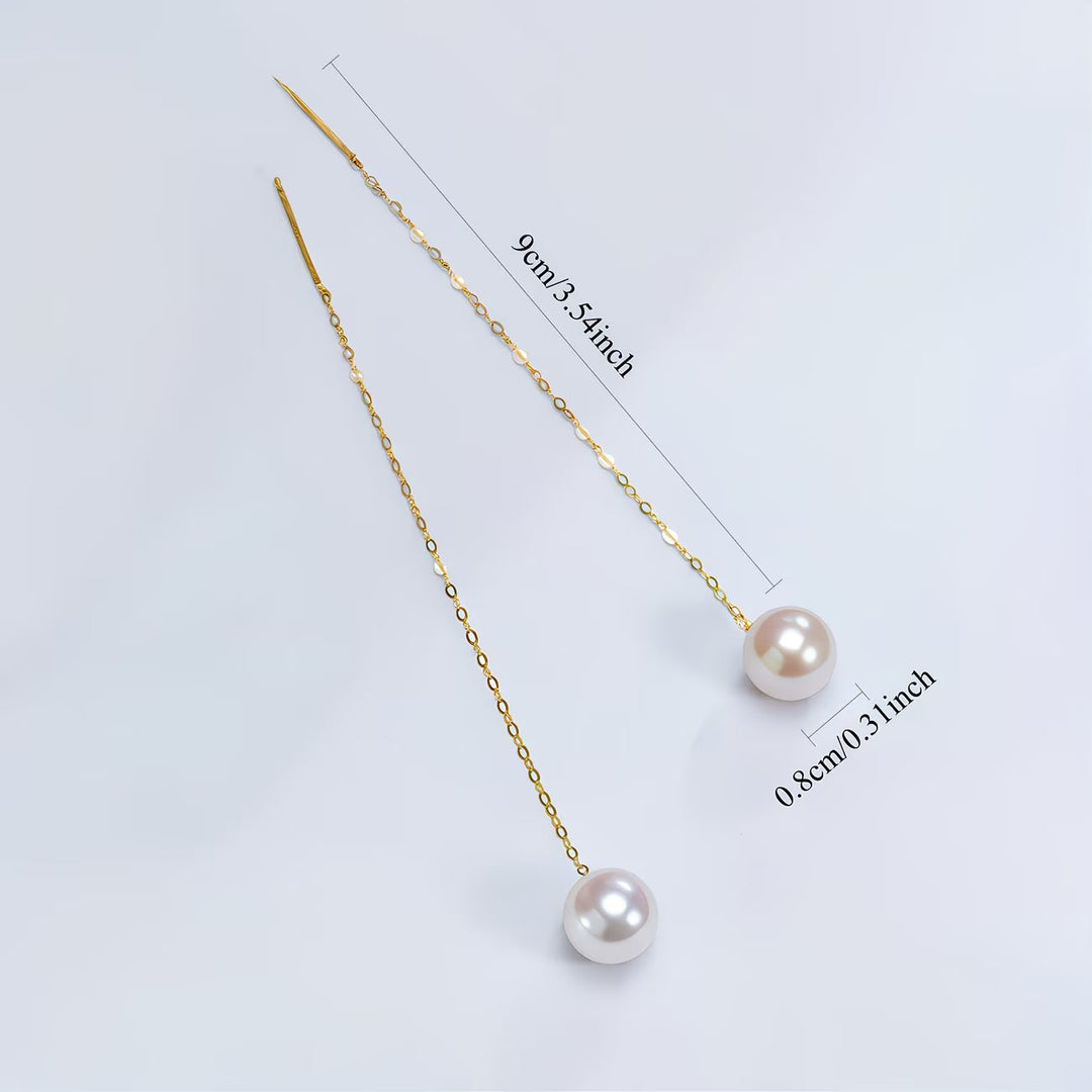 Earrings styled on a jewellery tray with soft lighting