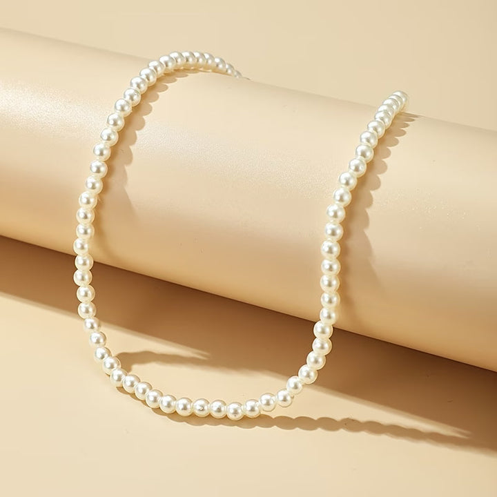 Close-up of the pearl necklace clasp and chain detail