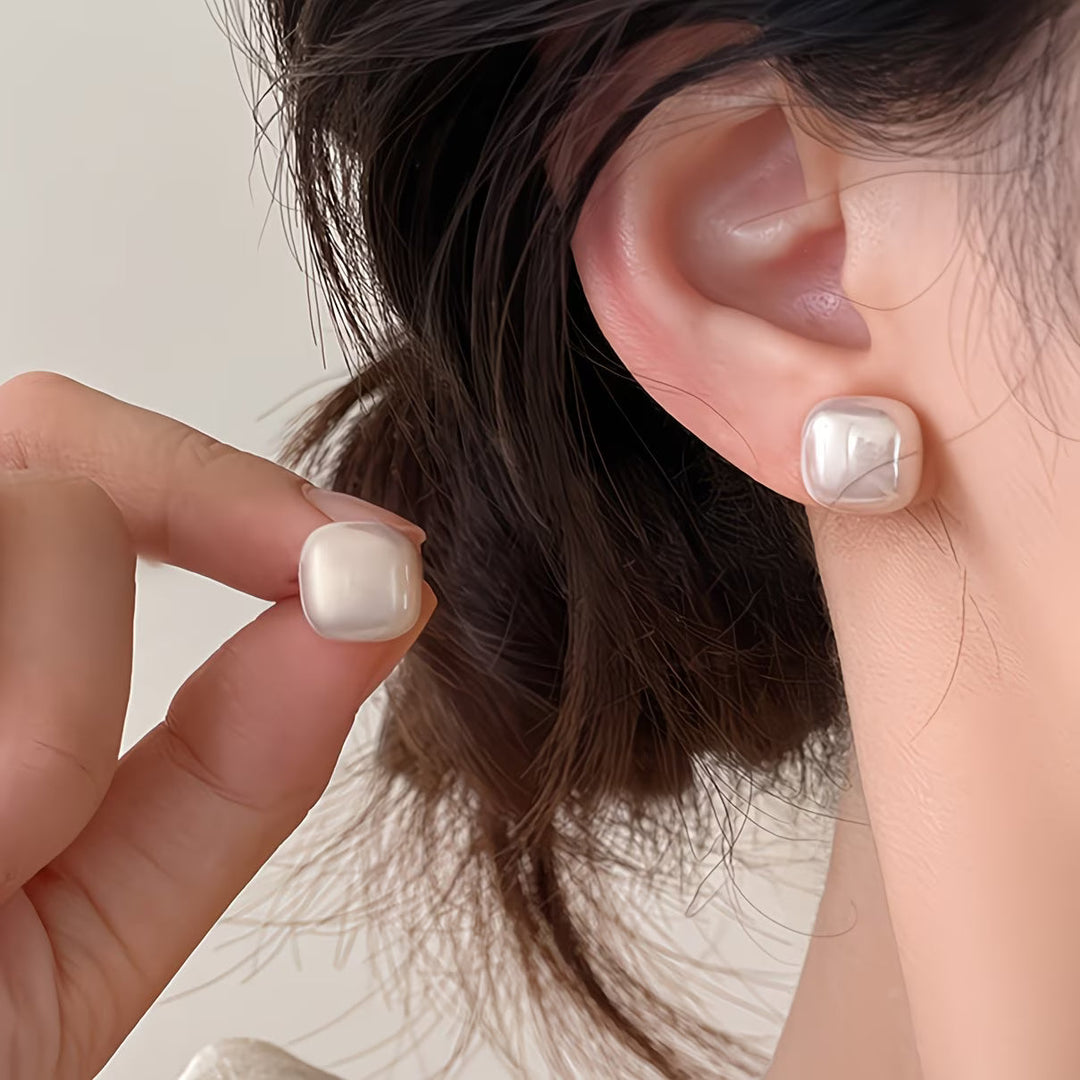 Close-up of the square-cut pearl and gold-tone setting