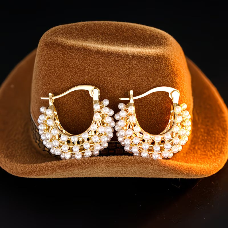 Close-up of pearls clustered along the chunky hoop earring